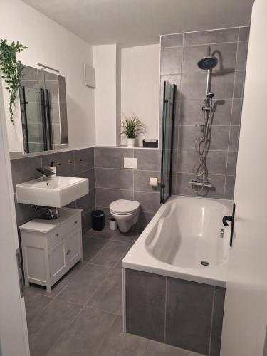 a bathroom with a tub and a sink and a toilet at Apartment am Gestütswegs EG 2 in Alt Krenzlin