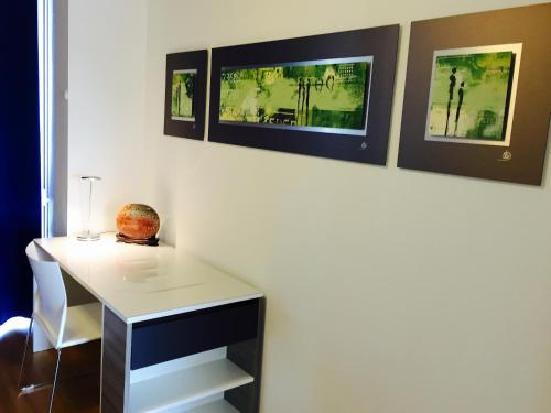 a room with a desk and two pictures on the wall at Rheinblick Riverview Luxury in Konstanz