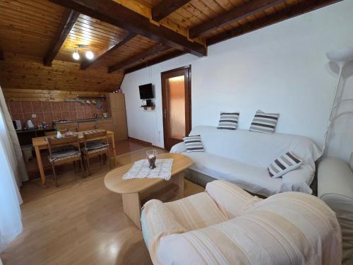 a living room with a bed and a table at Apartment Nina in Drežnik Grad