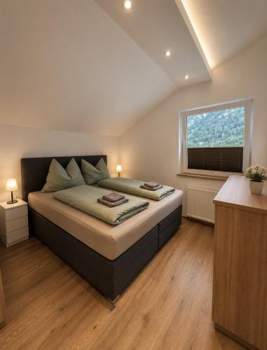 a bedroom with a large bed and a window at Haus Antonia in Zams