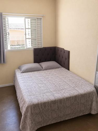 a bedroom with a large bed in a room at Pousada CTI in Taubaté