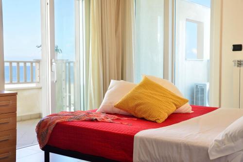 a bedroom with a bed with a large window at Residence A-More in Rimini