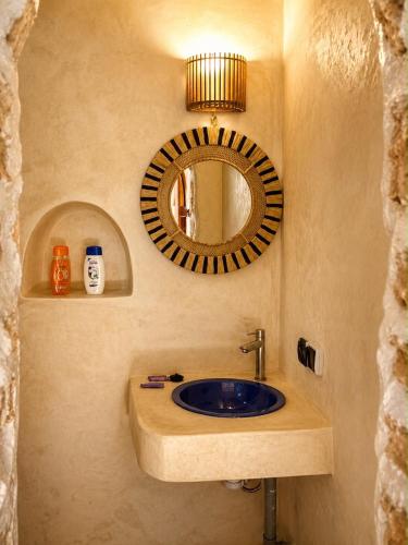 a bathroom with a sink and a mirror at SIDI KaouKI PERLA in Sidi Kaouki