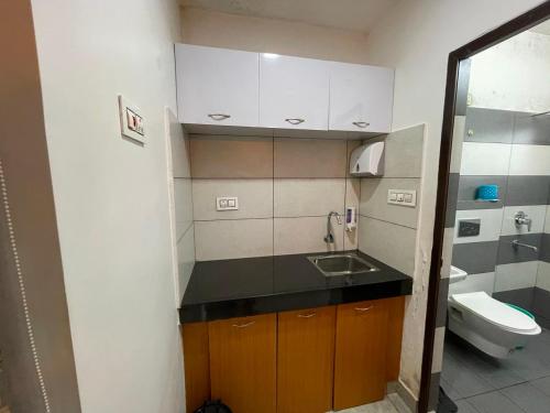 a small bathroom with a sink and a toilet at Blue Hills Resort Vythiri in Vythiri