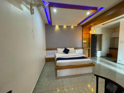 a bedroom with a bed with a purple ceiling at Blue Hills Resort Vythiri in Vythiri