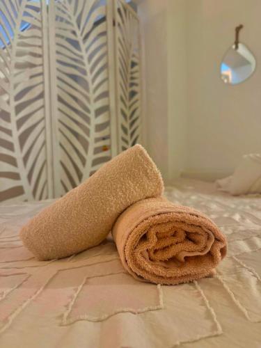 a towel sitting on top of a bed at Joli triplex proche Colmar in Sainte-Croix-en-Plaine