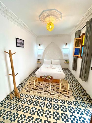 a bedroom with a bed and a cross on the floor at Riad Le Sultan Rouge And Spa in Marrakesh