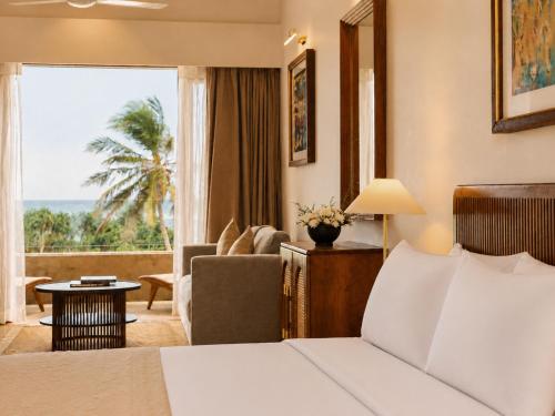 a hotel room with a bed and a living room at Rekawa Reach Tangalle in Tangalle