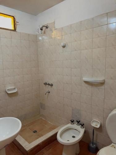 a bathroom with a shower and a toilet and a sink at Los Horneros in Santa María