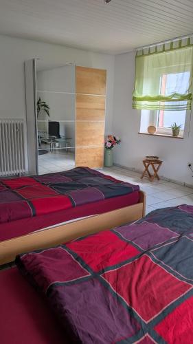 a bedroom with two beds and a living room at Waldesruh in Pirmasens