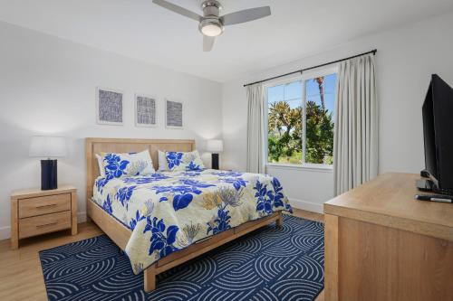 a bedroom with a bed and a tv and a window at Fairway Villas Waikoloa by OUTRIGGER in Waikoloa