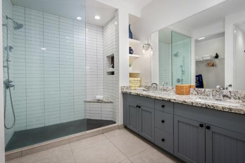 a bathroom with two sinks and a shower at Fairway Villas Waikoloa by OUTRIGGER in Waikoloa