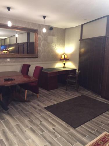 a room with a desk and a table and a chair at Tides Apartments Liscannor in Liscannor