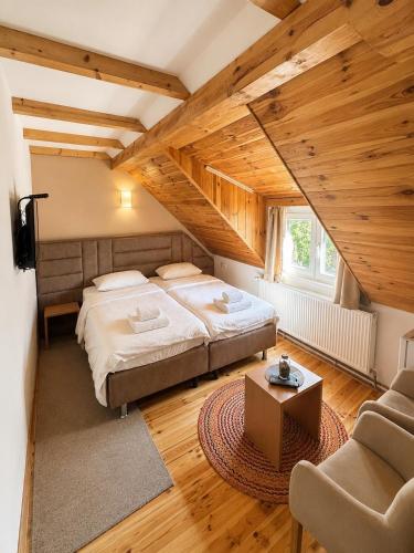 a bedroom with two beds and a table in a room at Apartments Radović in Kolašin