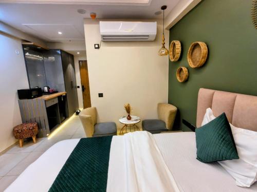 a hotel room with a bed and a table at Cozyco Stays in Nalmatha