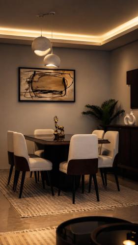 a dining room with a table and white chairs at ZED Towers City View Apartment in Sheikh Zayed