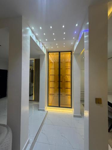 a hallway with a glass door in a building at Xclusive Luxury Apt in Mopo Onijebu