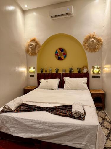a bedroom with a large bed in a room at Dar Zagora Oasis - Authentic Moroccan Stay in Zagora