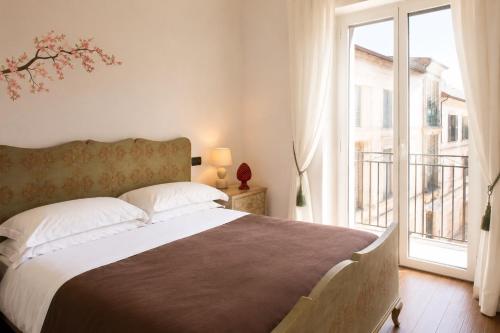 a bedroom with a large bed and a large window at Archivio 32 in Caserta