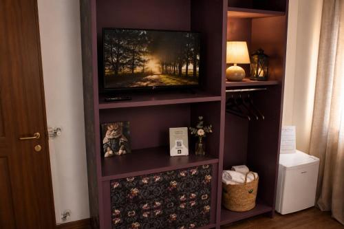 a television in a book shelf in a room at Archivio 32 in Caserta
