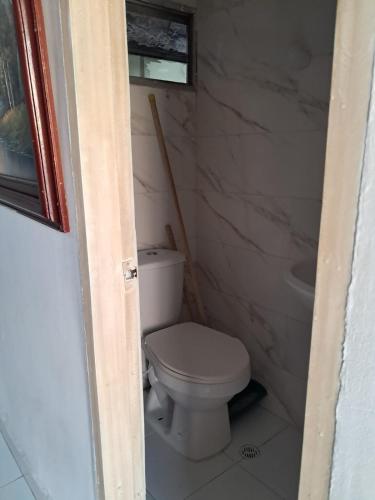 a small bathroom with a toilet and a tub at Cabañas Calipso # 7 in Coveñas