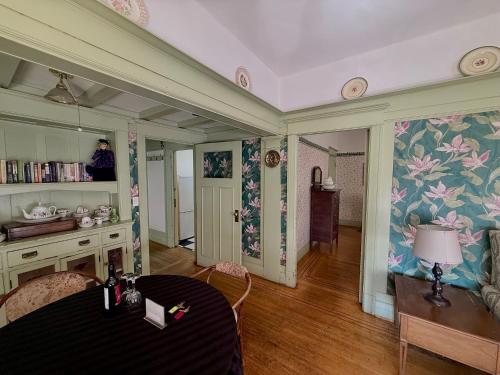 a dining room with a table and a person taking a picture at Arundel Mansions Hotel in New Westminster