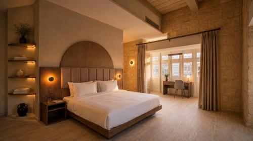 a bedroom with a bed and a desk in a room at St Anne Palace by Tritoni Prestige in Il-Furjana