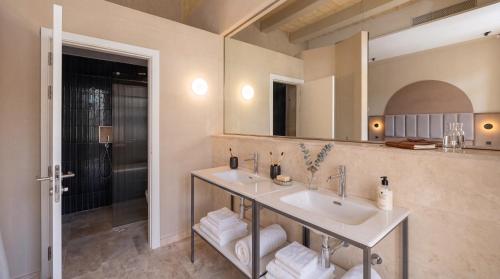 a bathroom with two sinks and a large mirror at St Anne Palace by Tritoni Prestige in Il-Furjana