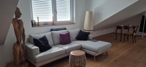 a living room with a couch and a table at Badischer Neubau-Ruhe-Kunst-Natur in Rheinau