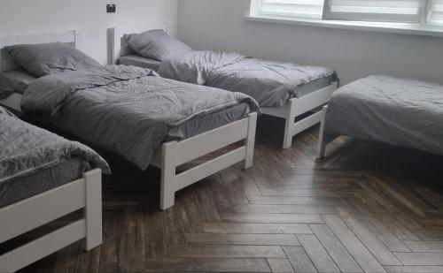 a room with three beds and a window at Гостинний дім in Shom