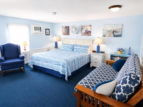a bedroom with a bed and a chair at A Beach Breeze Inn in West Harwich