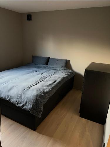a bedroom with a bed and a night stand at The Eikorn House in Skien
