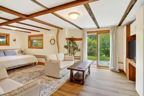 a bedroom with a bed and a couch and a tv at Steps to Beach: Martha's Vineyard Private Retreat! in Vineyard Haven