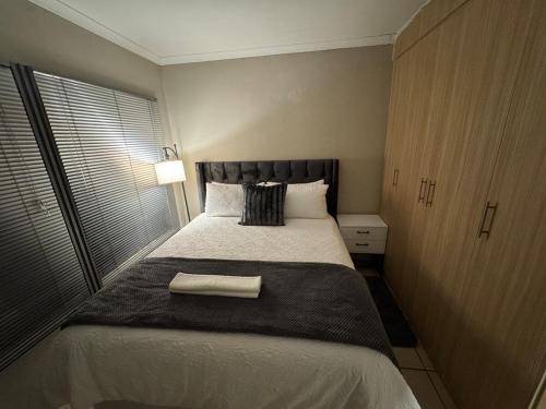 a bedroom with a large bed with a towel on it at Hei Stays One Bed Apartment in Bronkhorstspruit
