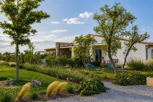 a house with a garden in front of it at Casale Oliveta & Ristorante in Orbetello