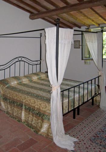 a bedroom with a bed with curtains on it at Villa Da Vinci in Vinci
