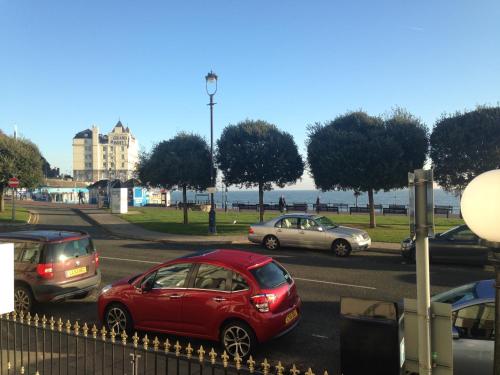 a group of cars driving down a street at Lauriston & Lawton Court Hotel in Llandudno