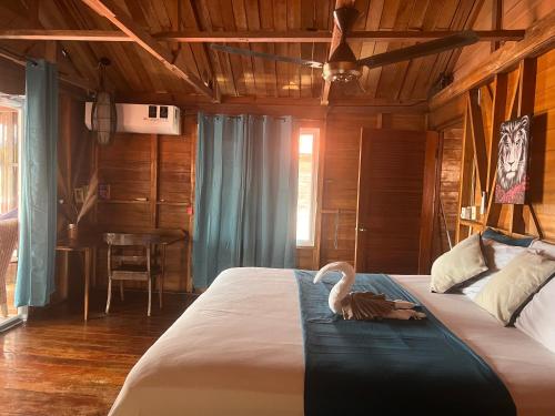 a bedroom with a large bed with a swan on it at Villa Bahia Del Sol in Bocas Town