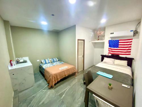 a bedroom with a bed and an american flag on the wall at Hospedaje Blue House - Consulado americano - Habitacion 2 in Guayaquil
