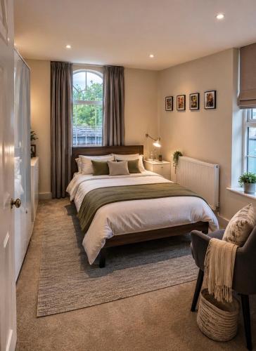 a bedroom with a large bed and a window at 5-bed house with indoor pool, Jacuzzi &Downs views in Herstmonceux