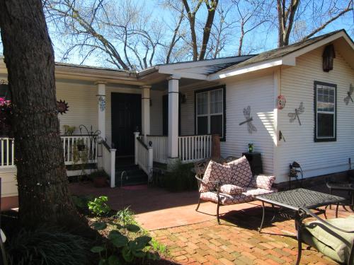 a house with a porch with a couch on a patio at The Carriage House in Jefferson