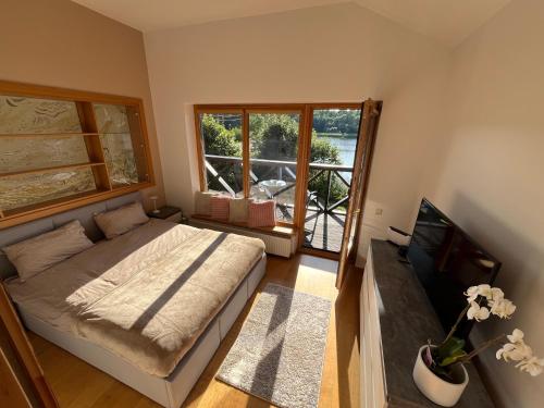 a bedroom with a bed and a tv and a window at Just Chill in Riga