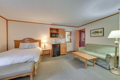 a hotel room with a bed and a couch at Dock, Direct Waterfront: Lake Champlain Studio in Willsboro
