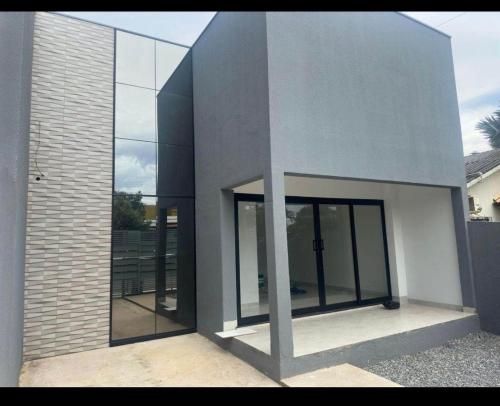 a building with glass doors on the side of it at Florence Nightingale in Sorriso