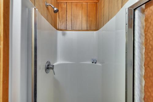 a bathroom with a shower and a white door at Lakeside Fun! Willsboro Studio w/ Dock + Fire Pit in Willsboro