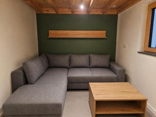 a living room with a couch and a table at Eiflia- Im Ourtal in Burg-Reuland
