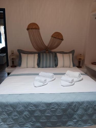 a bed with two towels on top of it at On The Waves Balcony in Klima