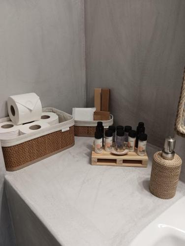 a bathroom with a sink and toiletries on a table at On The Waves Balcony in Klima