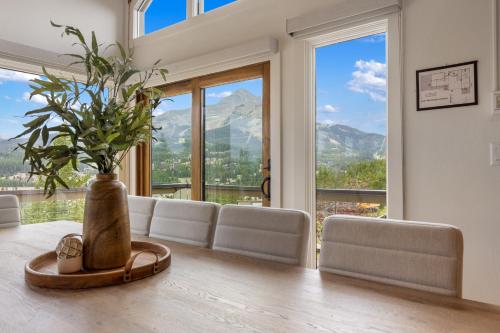 a dining room with a table with a vase on it at Lone Mountain Lookout in Big Sky