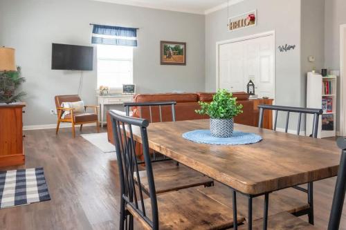 a living room with a wooden table and chairs at Cozy Cottage in Waco